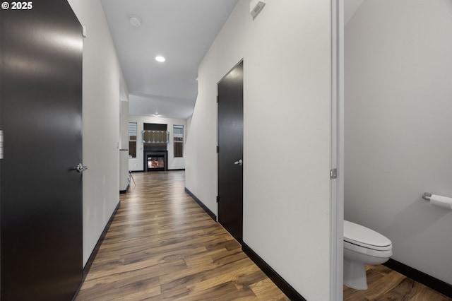 hall with recessed lighting, wood finished floors, and baseboards