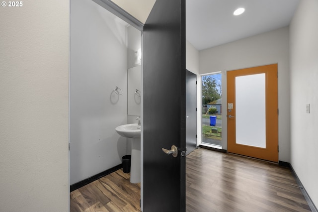 bathroom featuring a sink, recessed lighting, baseboards, and wood finished floors