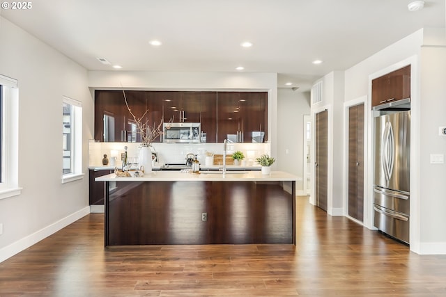 kitchen with stainless steel appliances, tasteful backsplash, modern cabinets, and light countertops
