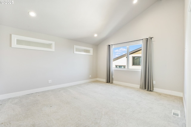 empty room with visible vents, baseboards, light colored carpet, lofted ceiling, and recessed lighting