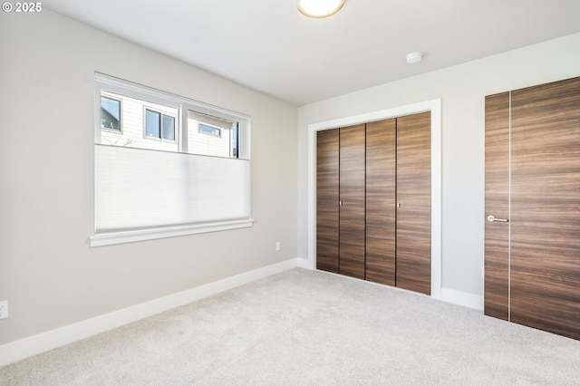 unfurnished bedroom with carpet flooring and baseboards
