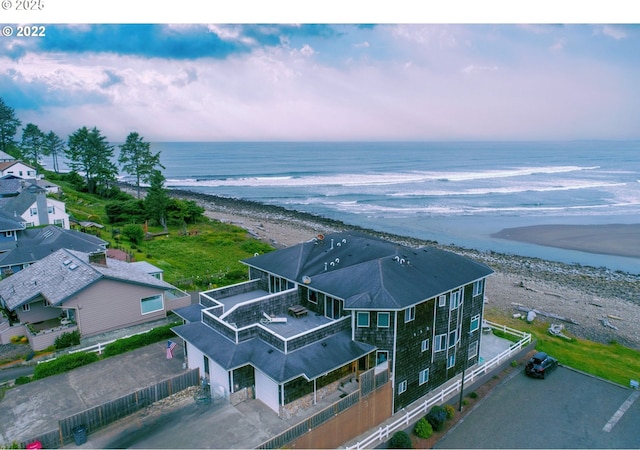 bird's eye view featuring a water view and a beach view