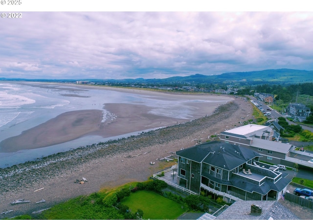 drone / aerial view featuring a water and mountain view