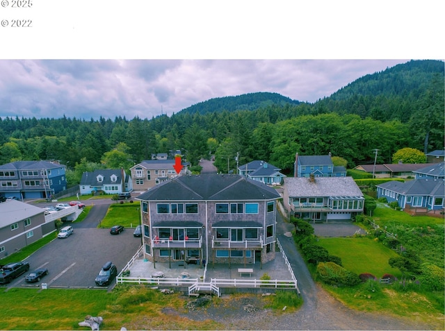 birds eye view of property with a residential view and a forest view