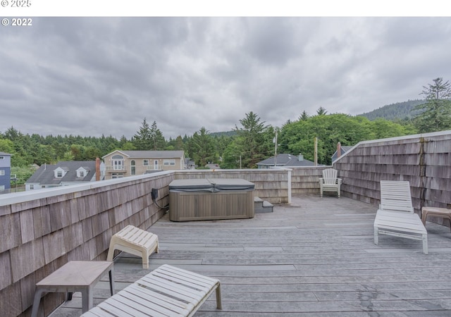 wooden deck with a hot tub