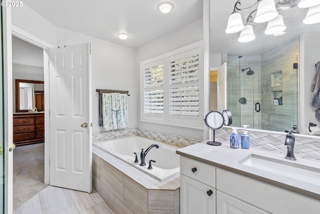 full bath with a stall shower, a garden tub, and vanity