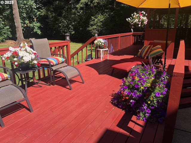 wooden terrace featuring a lawn