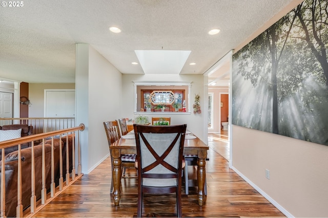 4212 NE 179th St, Vancouver, WA 98686 - dining space featuring a textured ceiling, wood finished floors, a skylight, baseboards, and recessed lighting
