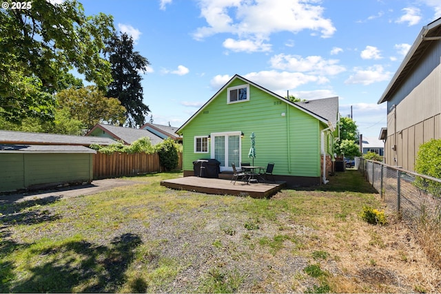 rear view of house with a wooden deck and central AC unit