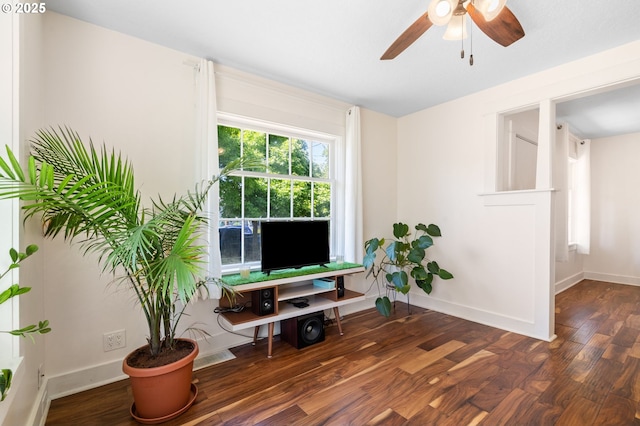 sitting room with a ceiling fan, wood finished floors, and baseboards
