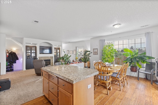 kitchen with a textured ceiling and light wood-type flooring