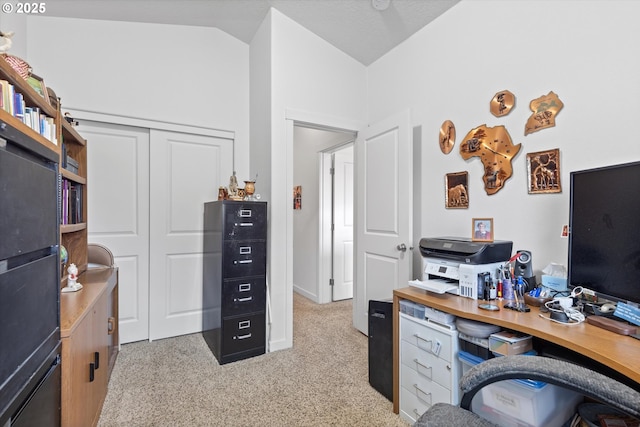 carpeted office space featuring vaulted ceiling