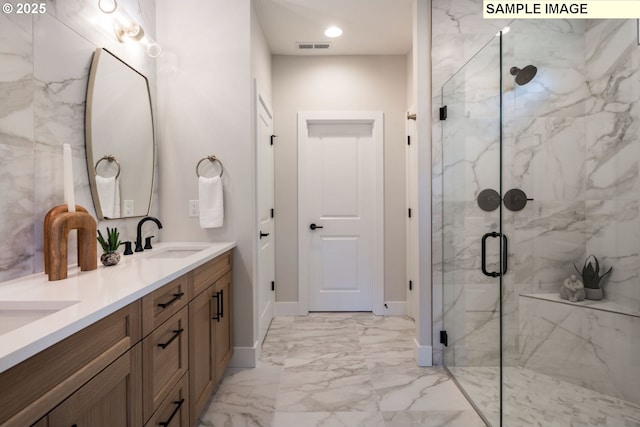 1143 N 41st Pl, Ridgefield, WA 98642 - bathroom featuring marble finish flooring, a marble finish shower, baseboards, and double vanity