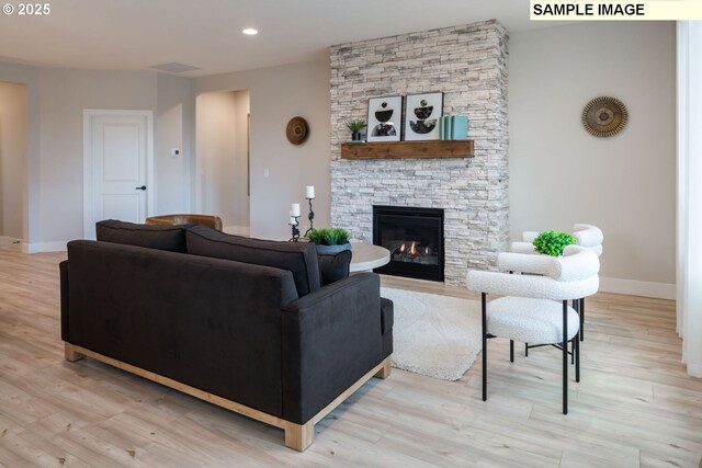 1143 N 41st Pl, Ridgefield, WA 98642 - living room with baseboards, a fireplace, light wood-type flooring, and recessed lighting