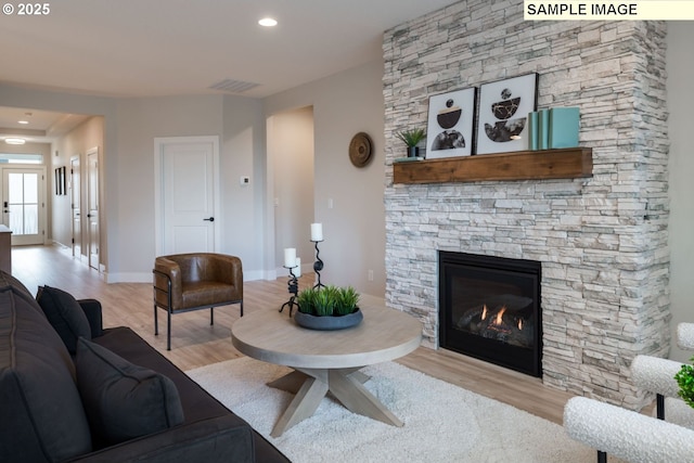 1143 N 41st Pl, Ridgefield, WA 98642 - living area with wood finished floors, a stone fireplace, and baseboards