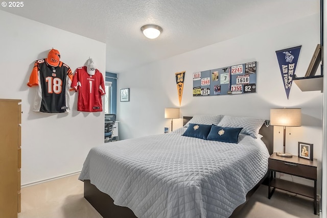 carpeted bedroom featuring a textured ceiling