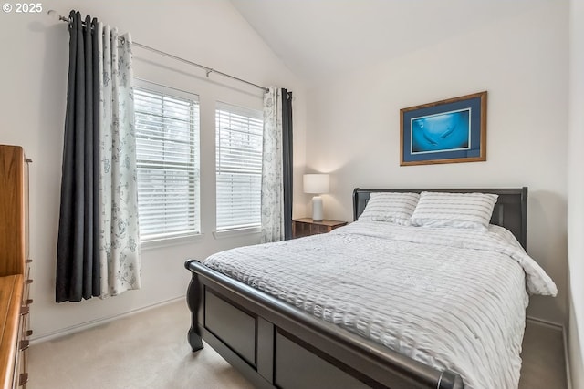 bedroom featuring light carpet and vaulted ceiling