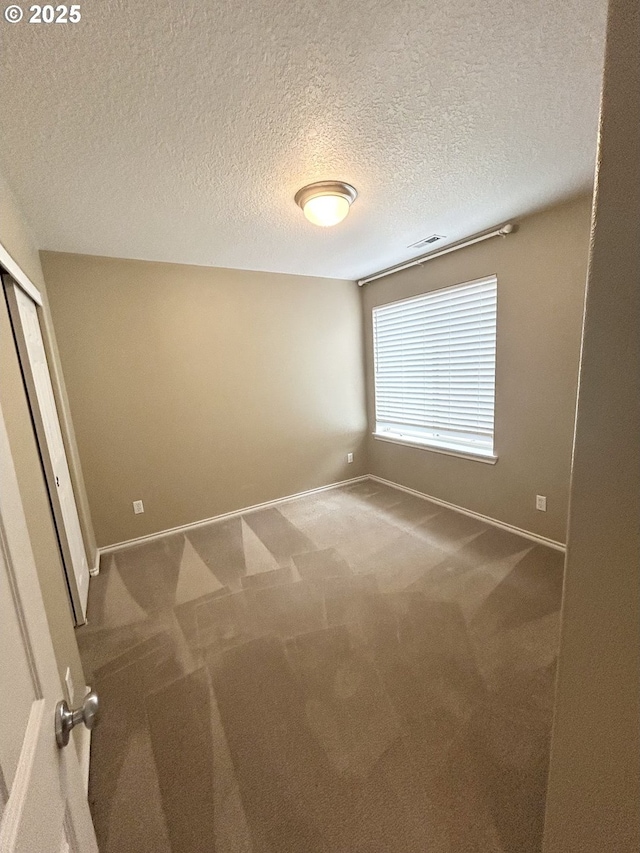 15779 SW Harvester Ln, Sherwood, OR 97140 - spare room featuring carpet floors, baseboards, and a textured ceiling