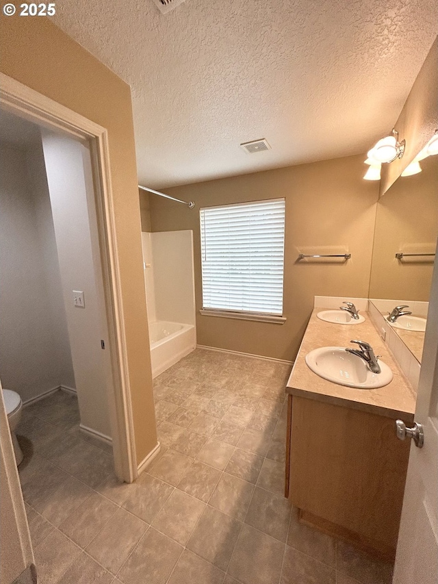 15779 SW Harvester Ln, Sherwood, OR 97140 - full bathroom featuring toilet, tub / shower combination, double vanity, tile patterned flooring, and a textured ceiling