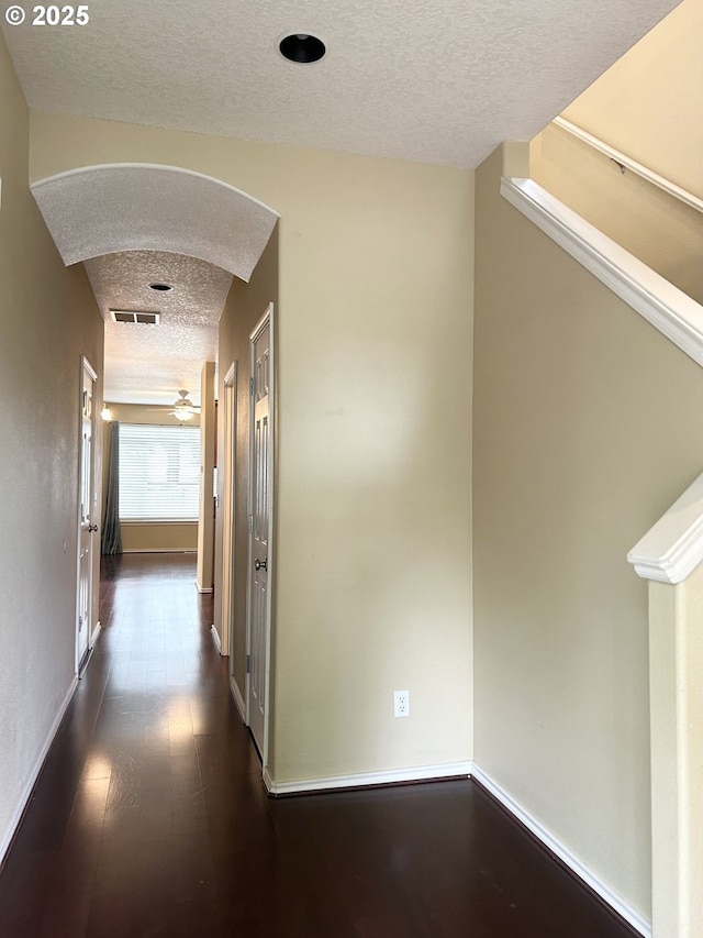 15779 SW Harvester Ln, Sherwood, OR 97140 - hall featuring a textured ceiling, dark wood-style floors, and baseboards