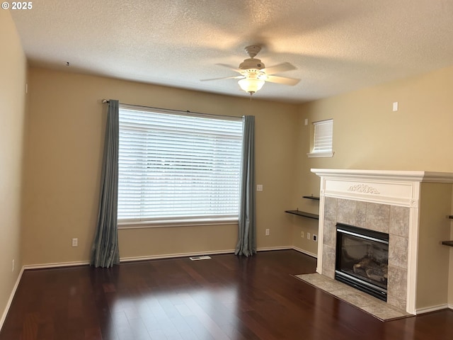 15779 SW Harvester Ln, Sherwood, OR 97140 - unfurnished living room featuring a fireplace, ceiling fan, wood finished floors, a textured ceiling, and baseboards