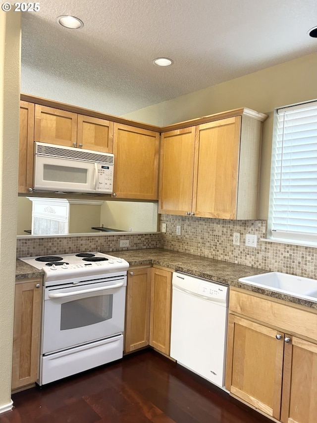 15779 SW Harvester Ln, Sherwood, OR 97140 - kitchen with white appliances, dark wood-style flooring, backsplash, a textured ceiling, and a sink