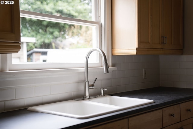 7817 SE Ellis St, Portland, OR 97206 - kitchen featuring a sink, dark countertops, and decorative backsplash