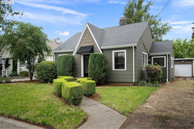 7817 SE Ellis St, Portland, OR 97206 - view of front of home featuring a chimney, a shingled roof, a front lawn, and driveway