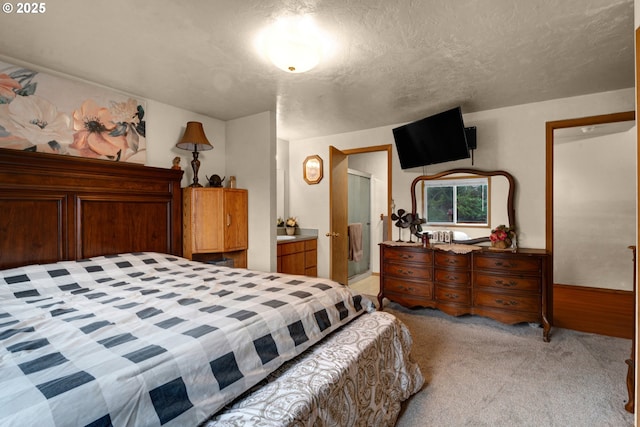 bedroom featuring light carpet and a textured ceiling