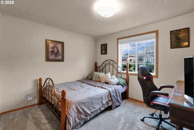 bedroom with carpet flooring, a textured ceiling, and baseboards