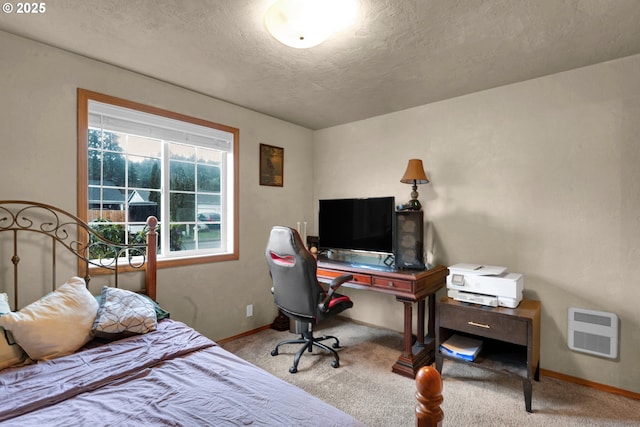 carpeted bedroom with baseboards and a textured ceiling