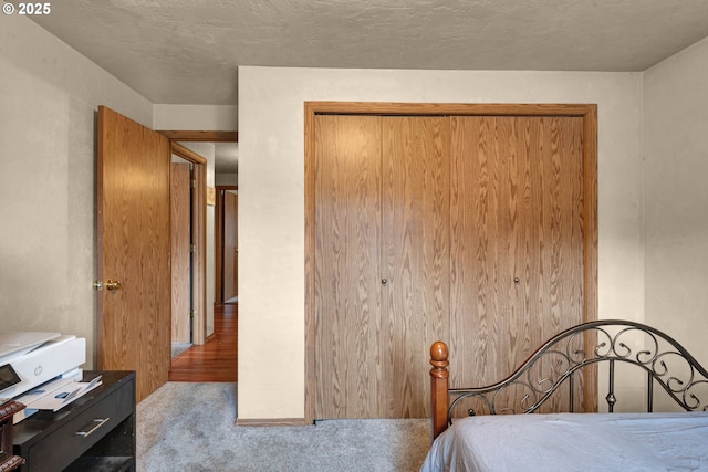 bedroom featuring light carpet and a closet