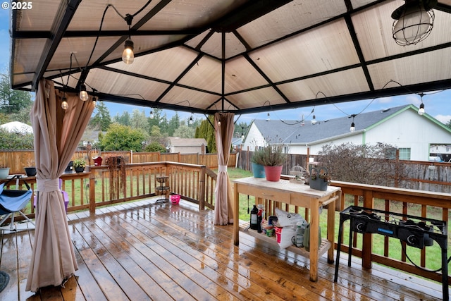 wooden deck featuring a fenced backyard and a gazebo