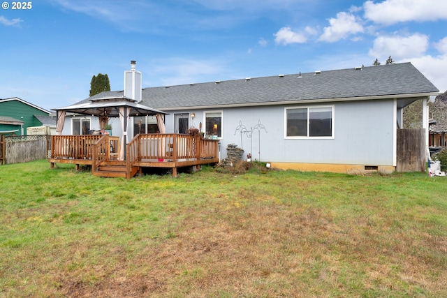 rear view of property with a shingled roof, fence, a gazebo, a yard, and a chimney