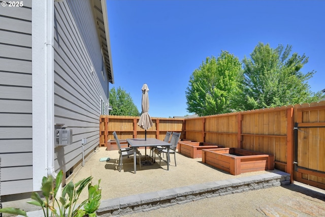 1027 Turtledove Loop, Lebanon, OR 97355 - fenced backyard with a patio, outdoor dining space, and a garden