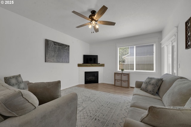 1027 Turtledove Loop, Lebanon, OR 97355 - living area featuring a ceiling fan, light wood-style flooring, and a glass covered fireplace
