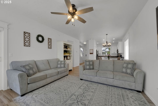 1027 Turtledove Loop, Lebanon, OR 97355 - living room with light wood-type flooring, a chandelier, a ceiling fan, healthy amount of natural light, and recessed lighting