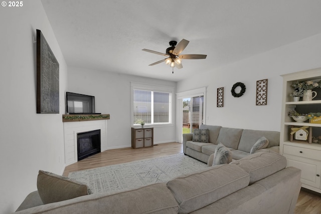 1027 Turtledove Loop, Lebanon, OR 97355 - living room with a ceiling fan, light wood-style flooring, and a fireplace