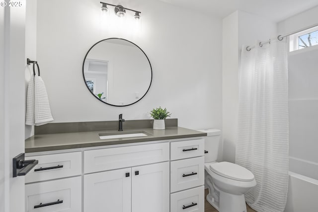 full bathroom featuring vanity, toilet, and shower / bath combo with shower curtain