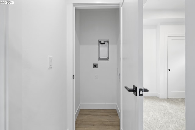 hall featuring light colored carpet