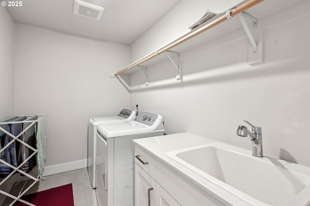 clothes washing area featuring cabinets, washer and clothes dryer, and sink