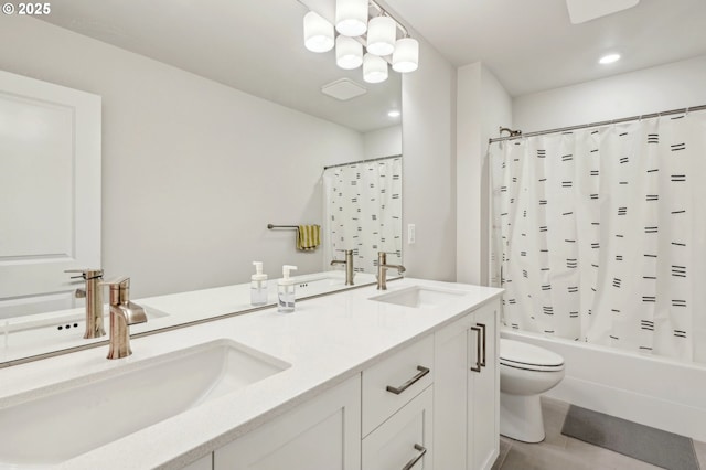 full bathroom with an inviting chandelier, vanity, toilet, and shower / bath combo with shower curtain