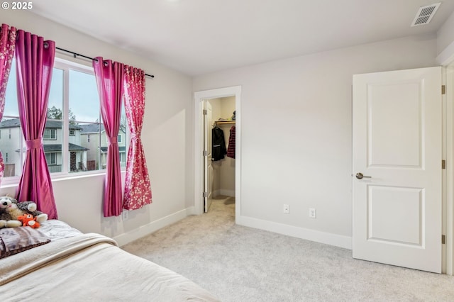 carpeted bedroom featuring a spacious closet