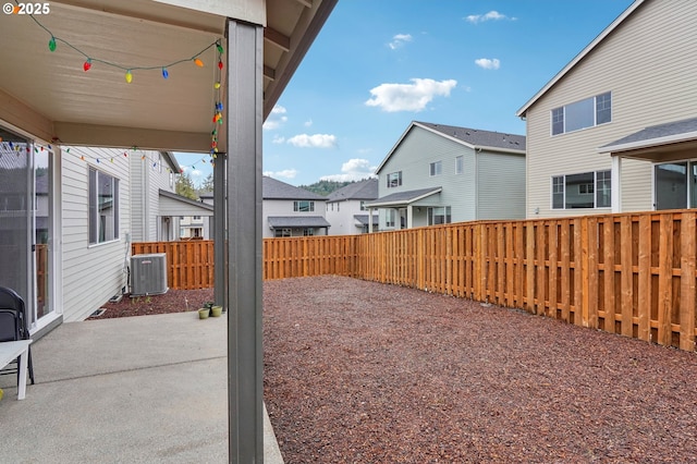 view of yard featuring cooling unit and a patio