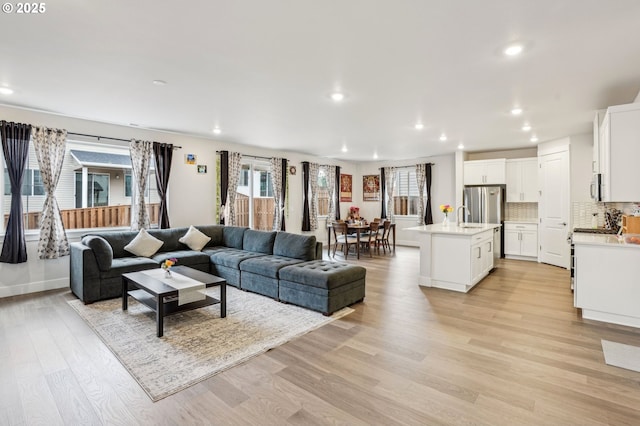 living room featuring sink and light wood-type flooring