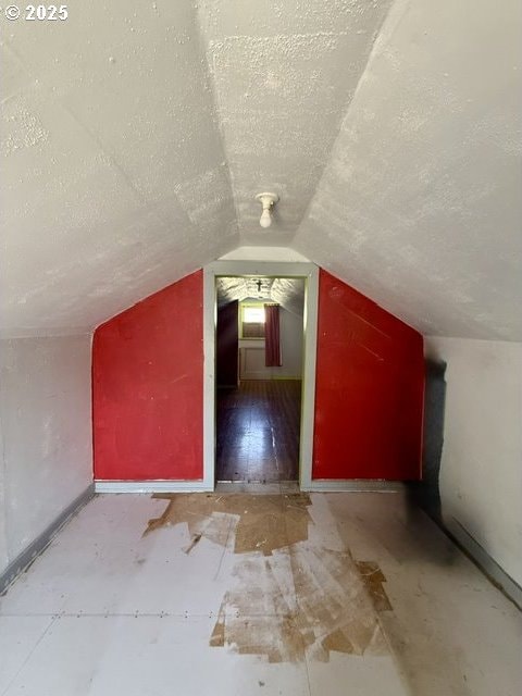 318 SW Brent Dr, John Day, OR 97845 - additional living space with a textured ceiling and vaulted ceiling