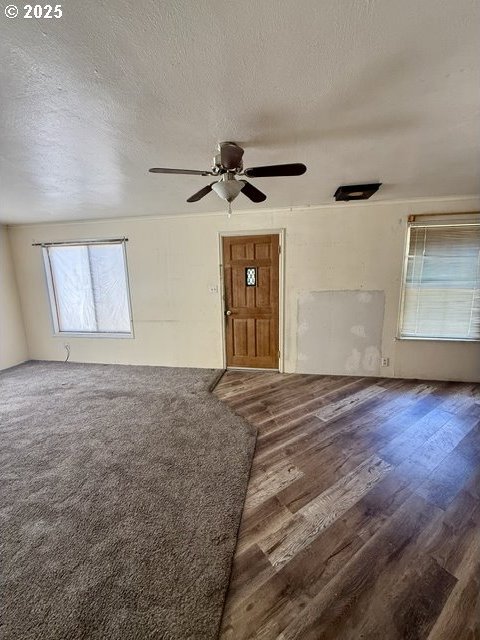 318 SW Brent Dr, John Day, OR 97845 - unfurnished living room featuring a ceiling fan, wood finished floors, and a textured ceiling