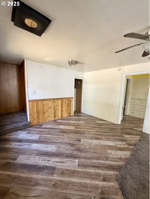 318 SW Brent Dr, John Day, OR 97845 - spare room with wood finished floors, a ceiling fan, wooden walls, and wainscoting