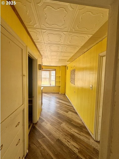 318 SW Brent Dr, John Day, OR 97845 - hall featuring an ornate ceiling, wooden walls, and dark wood-type flooring