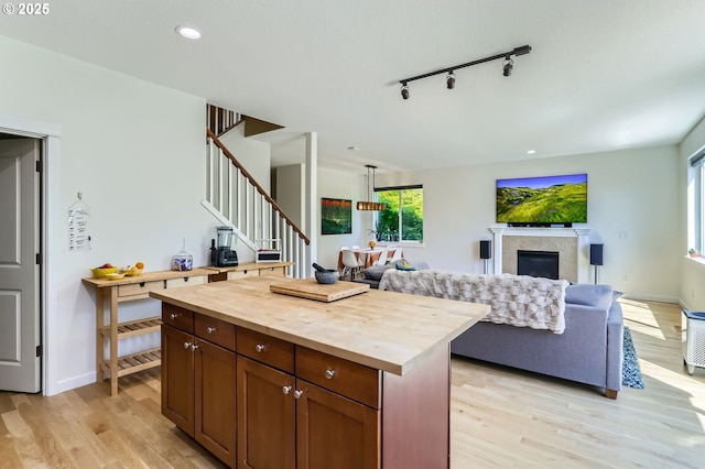 9288 SW Diamond View Way, Beaverton, OR 97007 - kitchen featuring wooden counters, light wood-style flooring, open floor plan, a center island, and recessed lighting